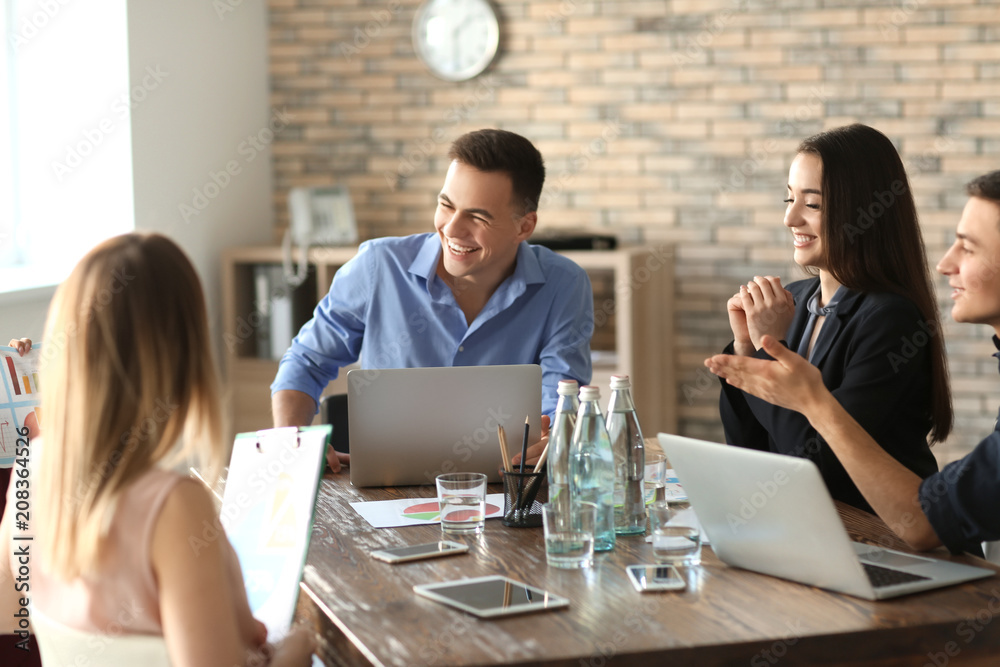 Young people having business meeting in office