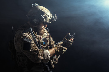 Wall Mural - Special forces soldier with rifle on dark background