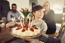 Man Holding Birthday Cake At Party