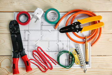 Wall Mural - Flat lay composition with electrical tools and house plan on wooden background