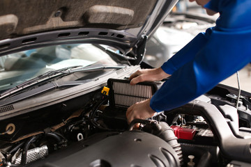 Wall Mural - Male mechanic examining car in service center