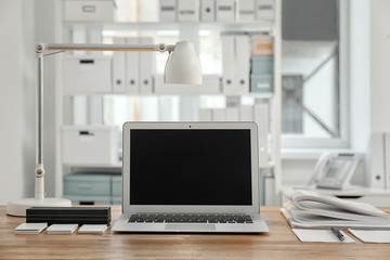 Stylish workplace with laptop on table