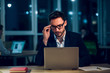 © Svyatoslav Lypynskyy - Businessman working in office late evening. Attractive business worker wearing white shirt with collar and jacket sitting in office working with laptop and fixing his glasses with his hand.