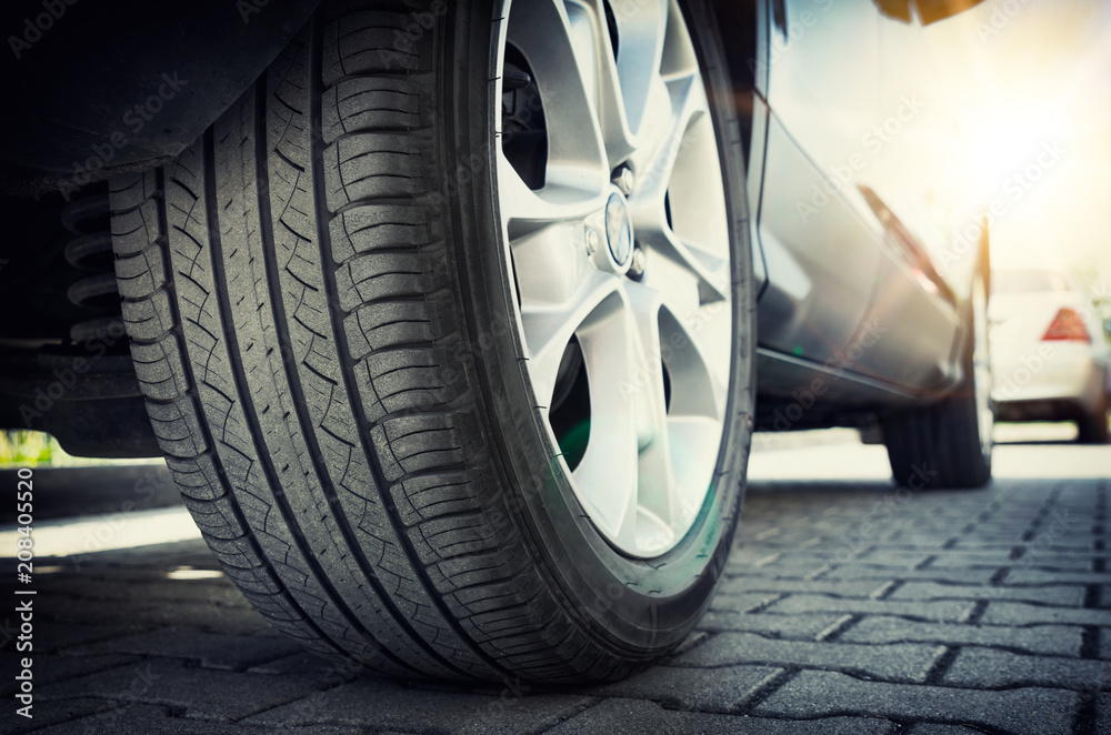 Car tire close up, parked car low angle shot