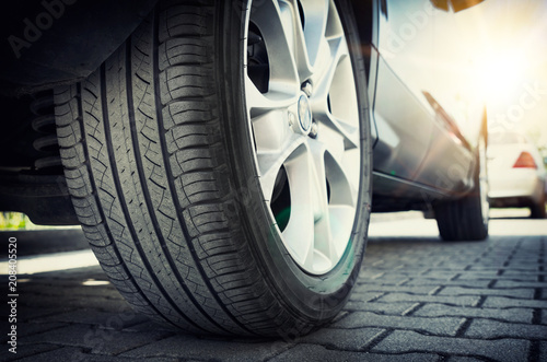 Fotomural Car tire close up, parked car low angle shot