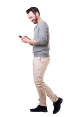 Wall Mural - Full length side of man walking with mobile phone