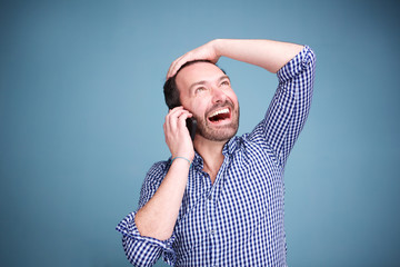 Wall Mural - Close up happy man talking on cellphone and looking up