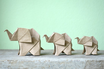 brown origami elephant on green background