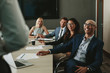 © Jacob Lund - Business people smiling during meeting in board room