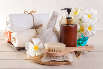 Spa massage and body scrub with towels compress balls and flowers