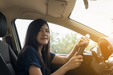 Hands of asian female driver on steering wheel,Woman driving a modern car