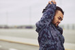 © Flamingo Images - Young African man warming up before an outdoor run