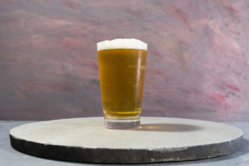 Poster - Glass of beer on a stone table background