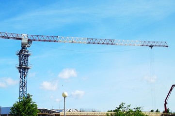 Construction and crane on a blue sky background.