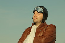 Vintage Pilot With Leather Cap, Scarf And Aviator Glasses  - Portrait Of A Man In Historical Pilot Clothing
