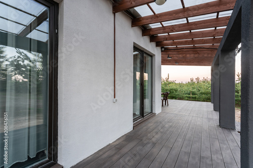Cuadros en Lienzo Side view of an open veranda in front of a modern forest cottage