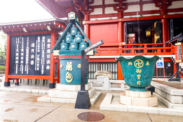 Wall Mural - Closeup of Green Sculptures near the temple Asakusa in rainy