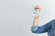 Asian woman holding a pink alarm clock on a white background. the concept of time management. get control of your life