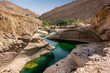 the refreshing cold water of the oasis of Wadi Bani Khalid in Oman