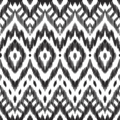 Wall Mural - The ornamental ikat pattern on ethnic style. Vector illustration in black and white colors. Exquisite seamless texture can be perfect for background images, wallpapers, textiles, wrapping papers.