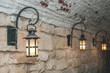 Old electric lights in a stone arch