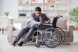 © Elnur - Dsabled businessman on wheelchair working home