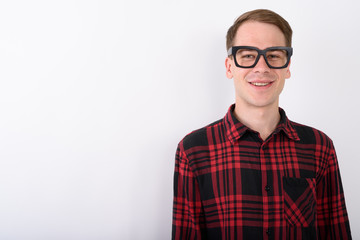 Wall Mural - Young handsome man wearing eyeglasses against white background