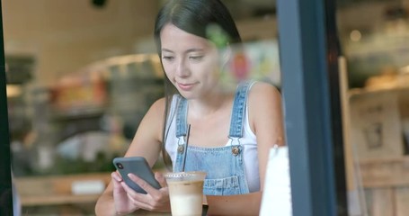 Poster - Woman use of smart phone inside coffee shop