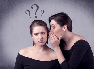 Wall Mural - A teenager girl looking confused with drawn question marks above the head, while a girlfriend whispers something in her ear concept.