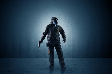 Wall Mural - Bad agent in a dark room with arms on his hand and gas mask
