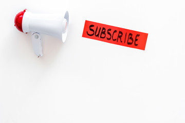 Poster - Subscribe template or mockup. Hand lettering subcribe near megaphone on white background top view space for text