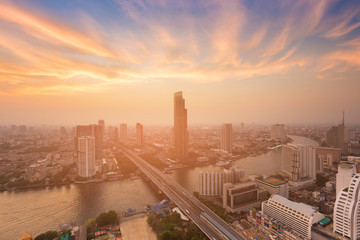 Wall Mural - River curved with city business downtown and sunset sky background