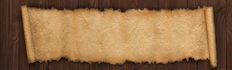 Wall Mural - panoramic background of old paper. unfolded scroll on the table