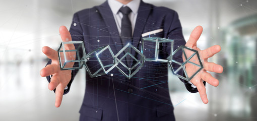 Poster - Businessman holding a 3d rendering blockchain cube isolated on a background