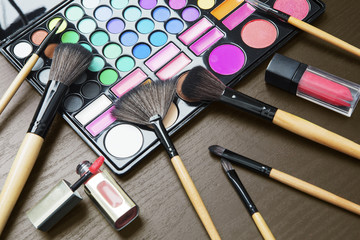 Wall Mural - Colorful eyeshadow palette with brushes on table