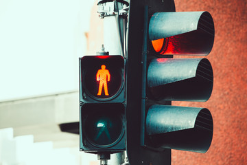 Red traffic and pedestrian crossing light closeup