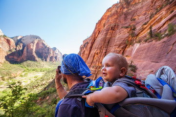 Wall Mural - A man with his baby boy are trekking in Zion national park, Utah, USA