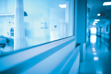 Canvas Print - Long hospital hallway with observation window to the ward