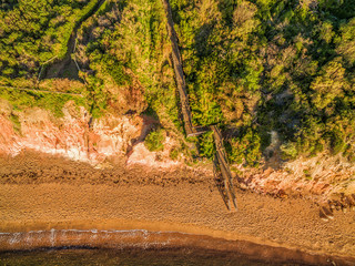 Wall Mural - Aerial view of wooden staircase leading to a beautiful ocean bay and beach