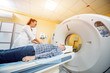 © romaset - Doctor and patient in the room of computed tomography at hospital.