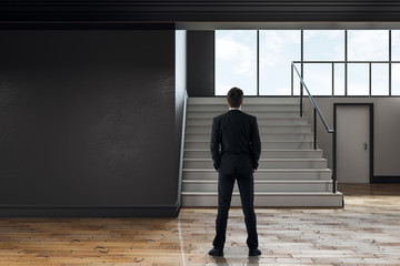 Poster - Businessman in modern school corridor