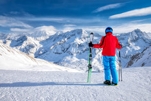 Young Happy Skier Standing On The Top Of Mountains And Enjoying View Of Rhaetian Alps, Tonale Pass, Italy, Europe