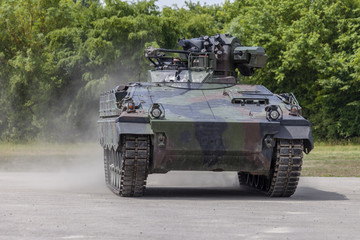 Wall Mural - German infantry fighting vehicle drives on a road