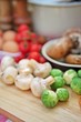 Assortment of fresh, raw vegetables for cooking on a wooden cutting board. Selective focus.
