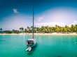 isolated sailboat anchoring in front of a white sand beach on Caribbean island - Mayreau - St Vincent and the Grenadines