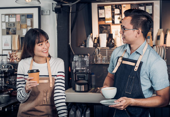 Poster - Two barista talking together about tasted of coffee cup with happy emotion at counter bar at cafe.coffee shop business owner concept,Service mind waiter.