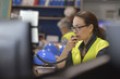 © goodluz - Woman in industrial control room using radio to give instructions