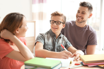 Sticker - Teenager with parents doing homework at home