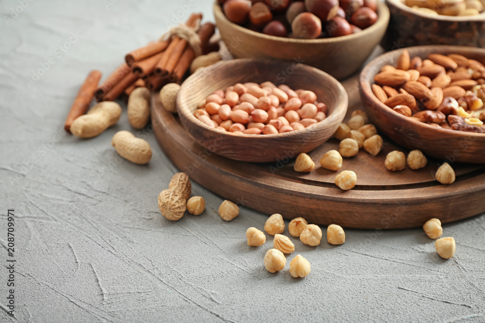 Different kinds of nuts in bowls on table