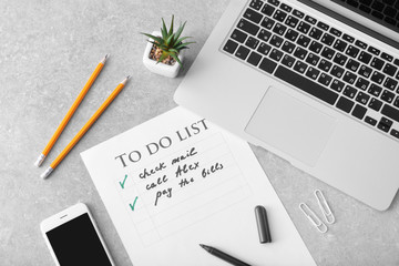 Composition with to-do list and laptop on grey background